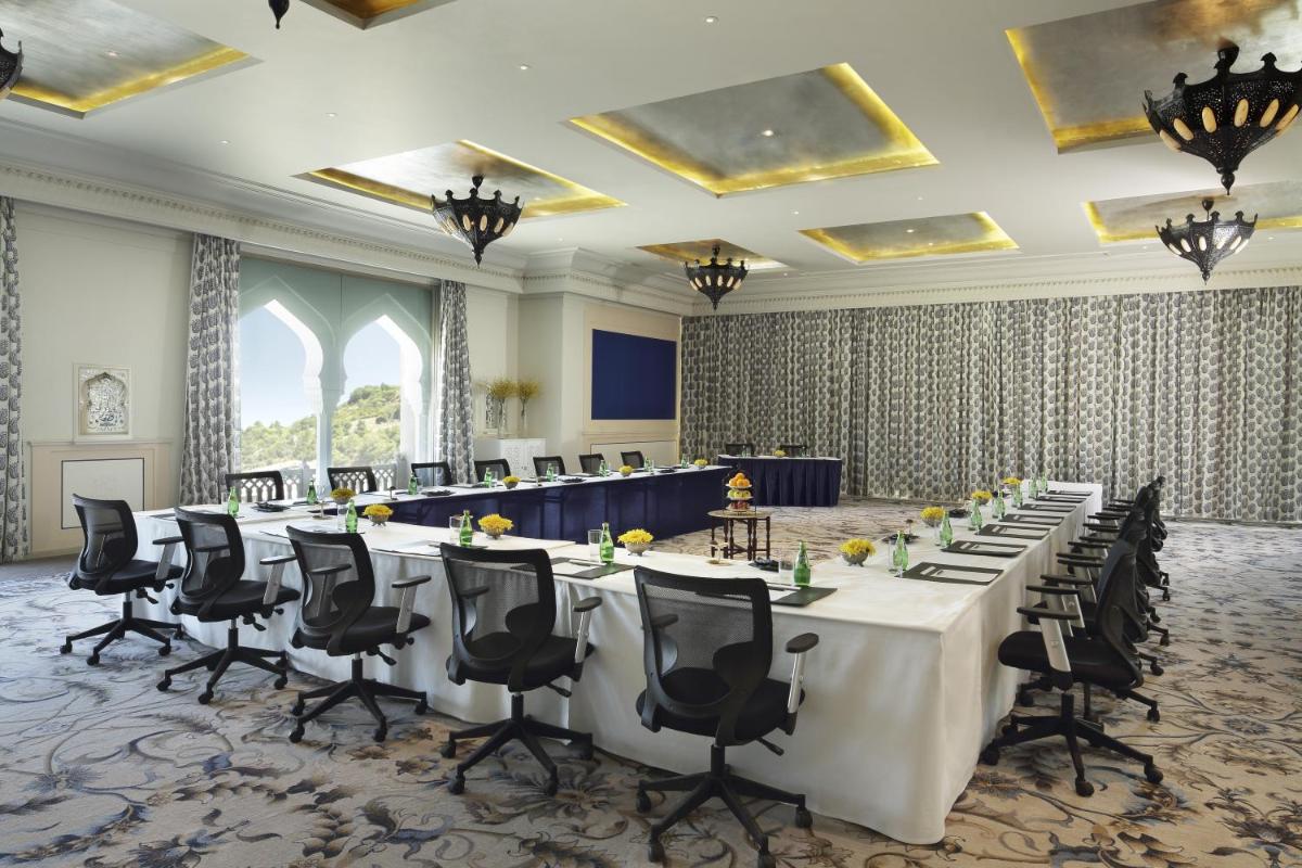a conference room with long tables and chairs at Fairmont Jaipur in Jaipur