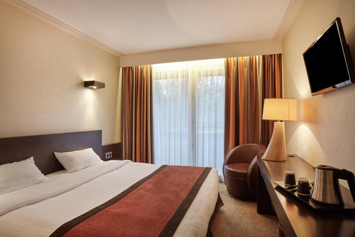 Un ou plusieurs lits dans un hébergement de l'établissement Hôtel Spa Du Béryl