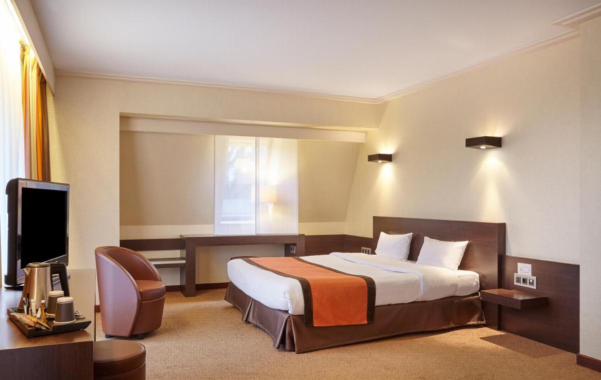 Un ou plusieurs lits dans un hébergement de l'établissement Hôtel Spa Du Béryl