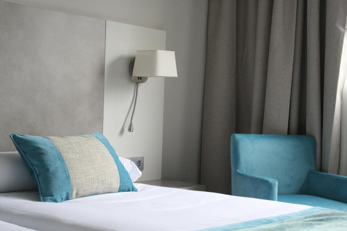 Cama o camas de una habitación en Hotel & Spa Real Jaca