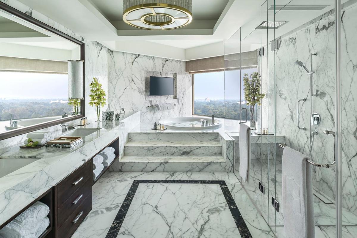 a bathroom with a tub and a sink at Shangri-La Eros New Delhi in New Delhi a bathroom with a tub and a sink at Shangri-La Eros New Delhi in New Delhi