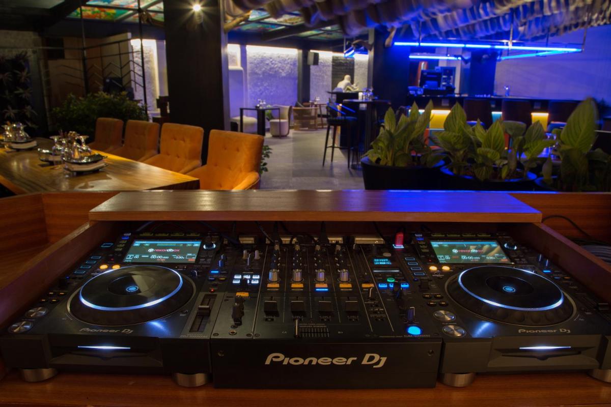 a mixing console in a room with a bar at The Accord Metropolitan in Chennai
