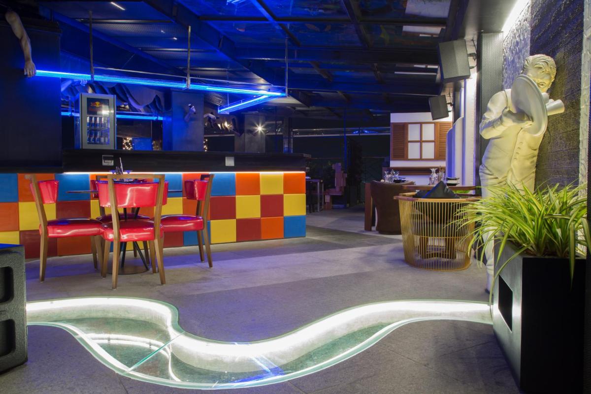 a room with a bar with a table and chairs at The Accord Metropolitan in Chennai