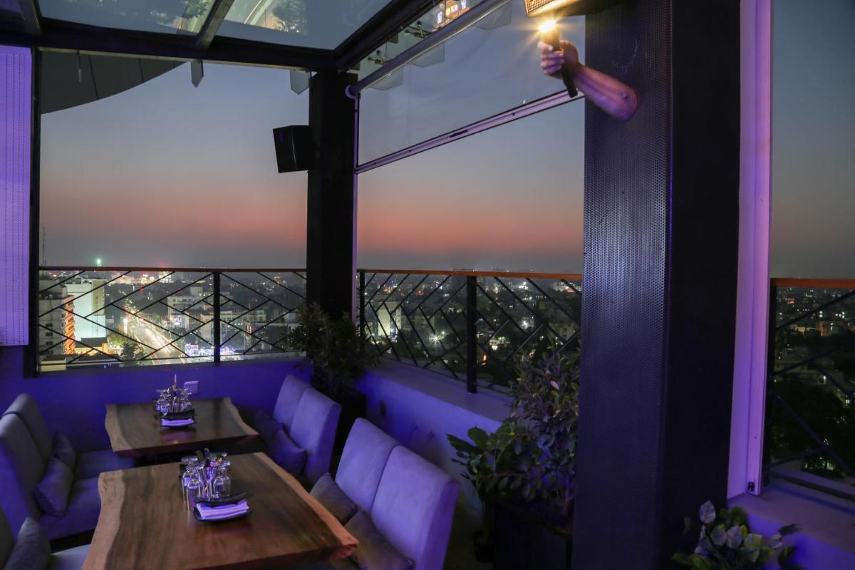 a room with tables and a view of the eiffel tower at The Accord Metropolitan in Chennai