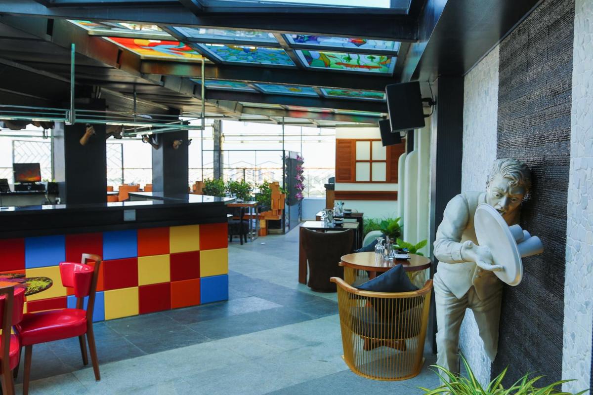 a statue of a man holding a frisbee in a restaurant at The Accord Metropolitan in Chennai