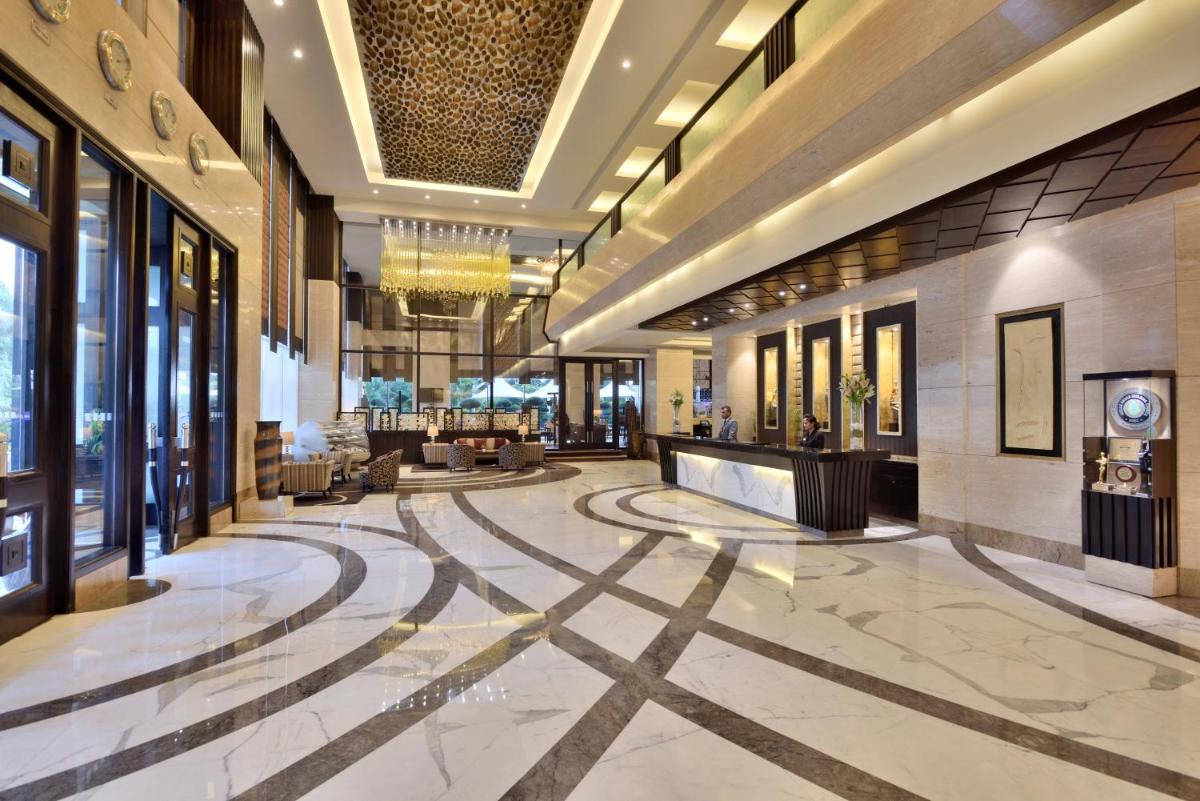 a lobby of a hotel with a large lobby at Radisson Blu Hotel, Indore in Indore