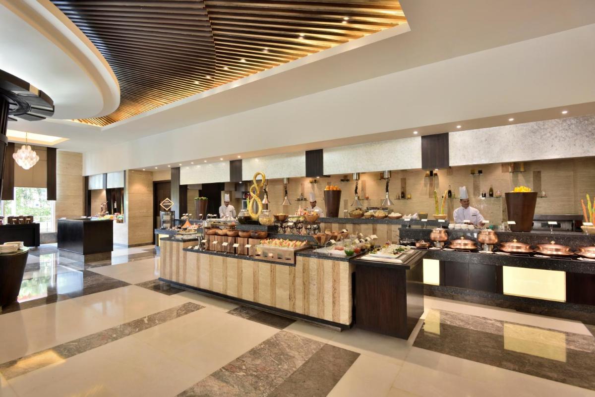 a lobby of a hotel with a buffet at Radisson Blu Hotel, Indore in Indore