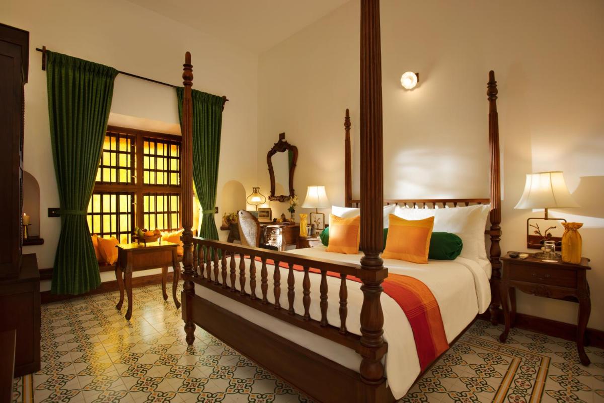 a bedroom with a large bed and a window at Forte Kochi in Cochin