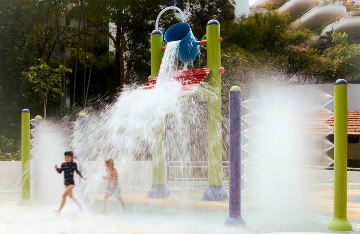 two children playing in a water park at Shangri-La Singapore in Singapore two children playing in a water park at Shangri-La Singapore in Singapore