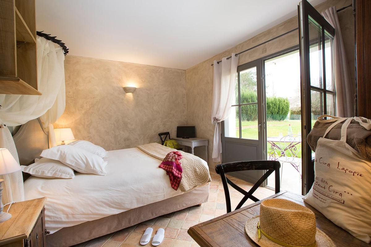 Un ou plusieurs lits dans un hébergement de l'établissement Hôtel-Spa Le Saint Cirq