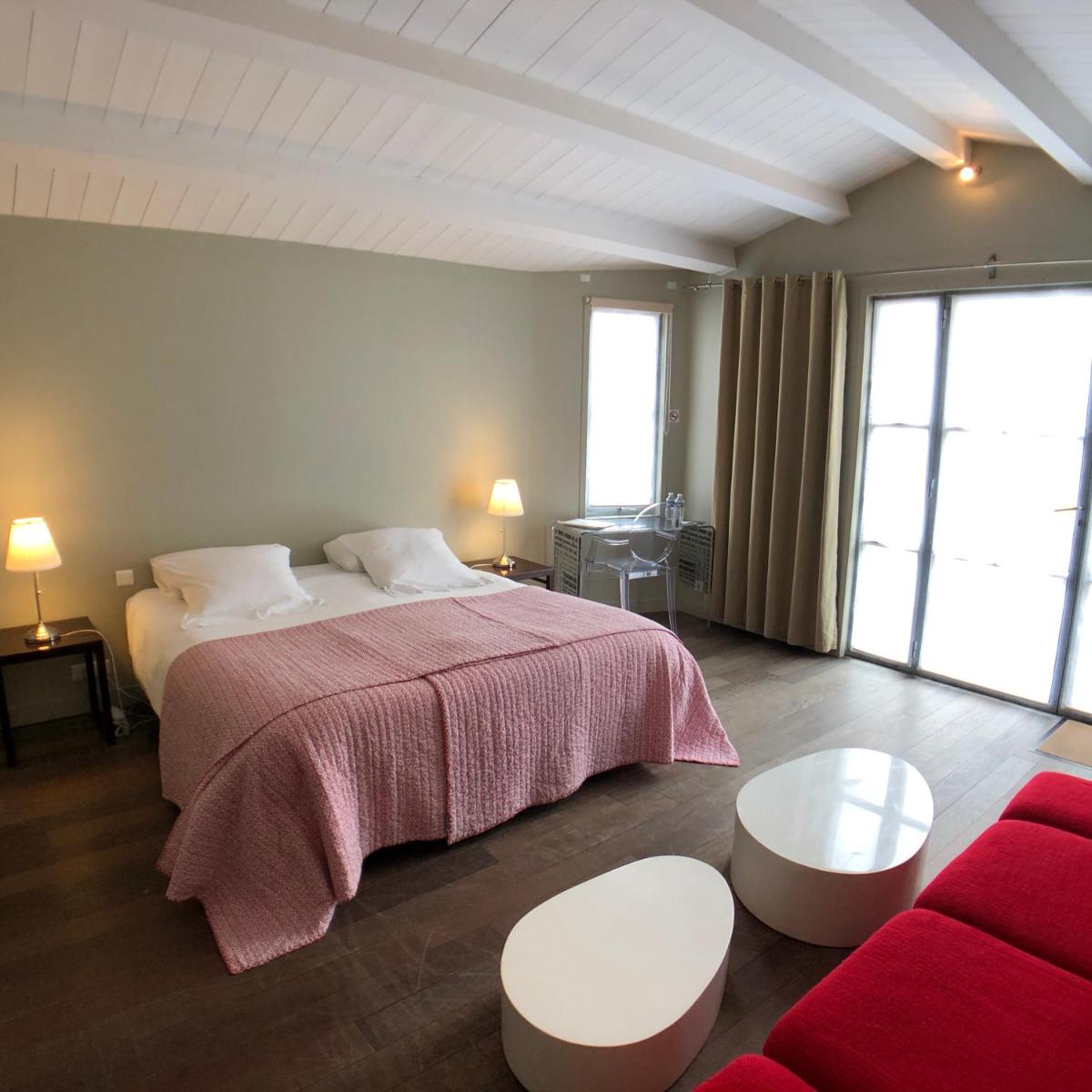 Un ou plusieurs lits dans un hébergement de l'établissement Hotel L'Océan