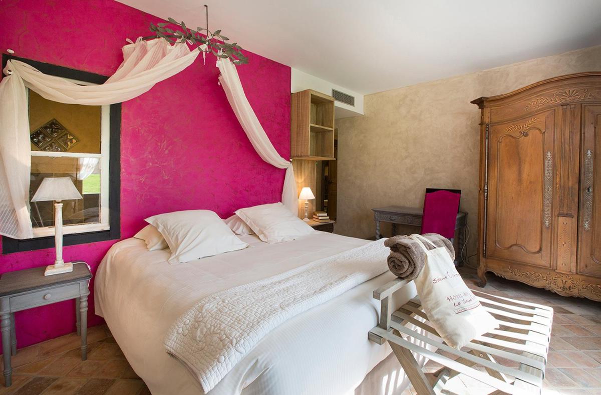 Un ou plusieurs lits dans un hébergement de l'établissement Hôtel-Spa Le Saint Cirq