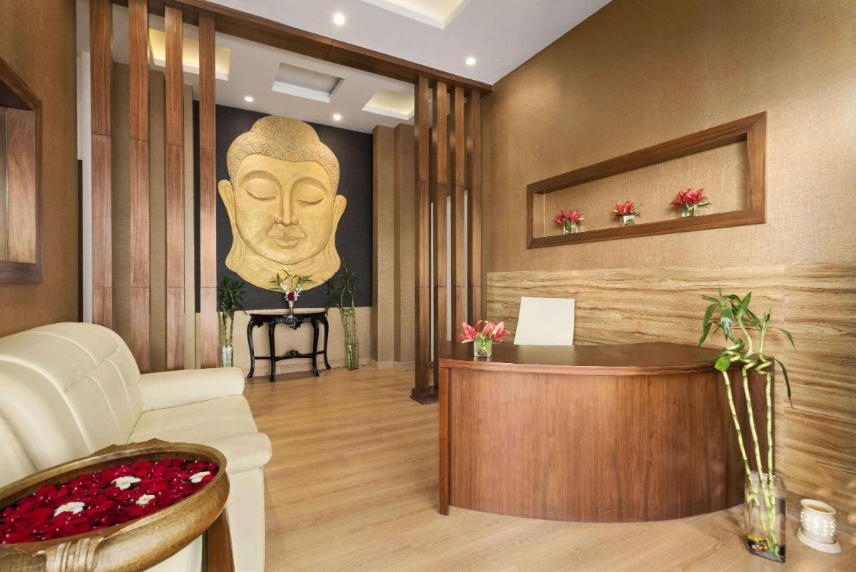 a living room with a large head on the wall at Saura Hotel, Agra - A Club Mahindra Associate in Agra