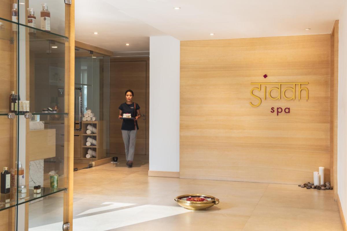 a woman walking in a store with a sign on the door at Hyatt Regency Lucknow Gomti Nagar in Lucknow