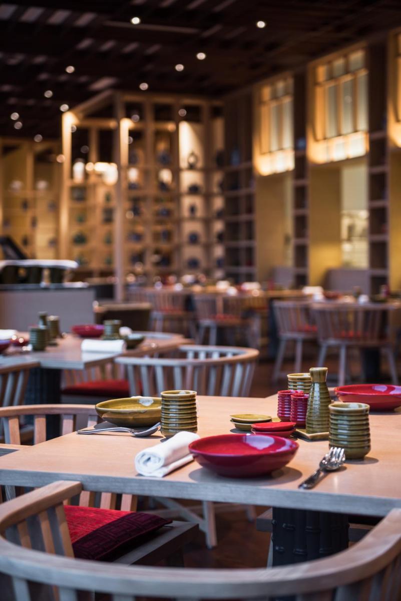 a table with plates and napkins on it in a restaurant at Hyatt Regency Lucknow Gomti Nagar in Lucknow