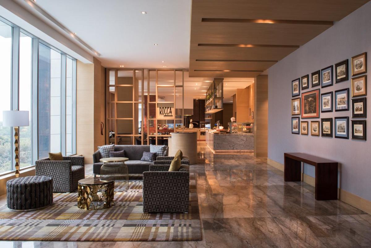 a living room with a couch and a table at Hyatt Regency Lucknow Gomti Nagar in Lucknow