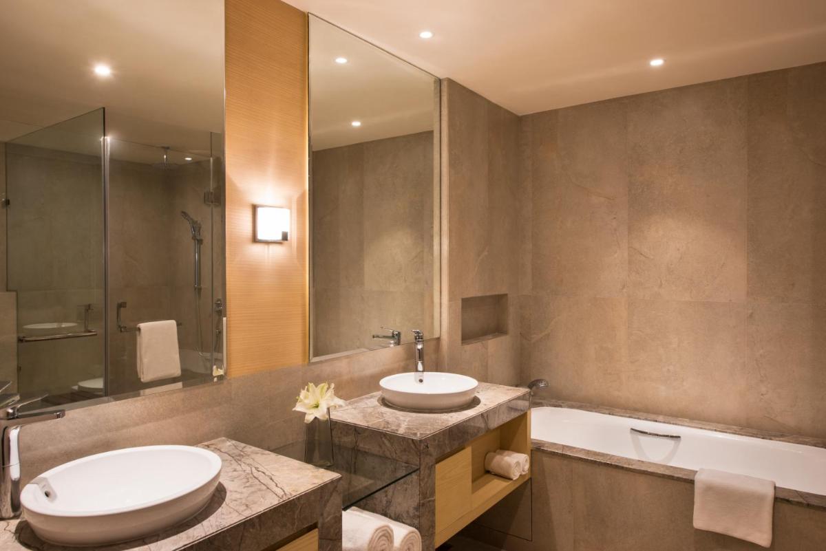 a bathroom with a sink and a toilet and a tub at Hyatt Regency Lucknow Gomti Nagar in Lucknow