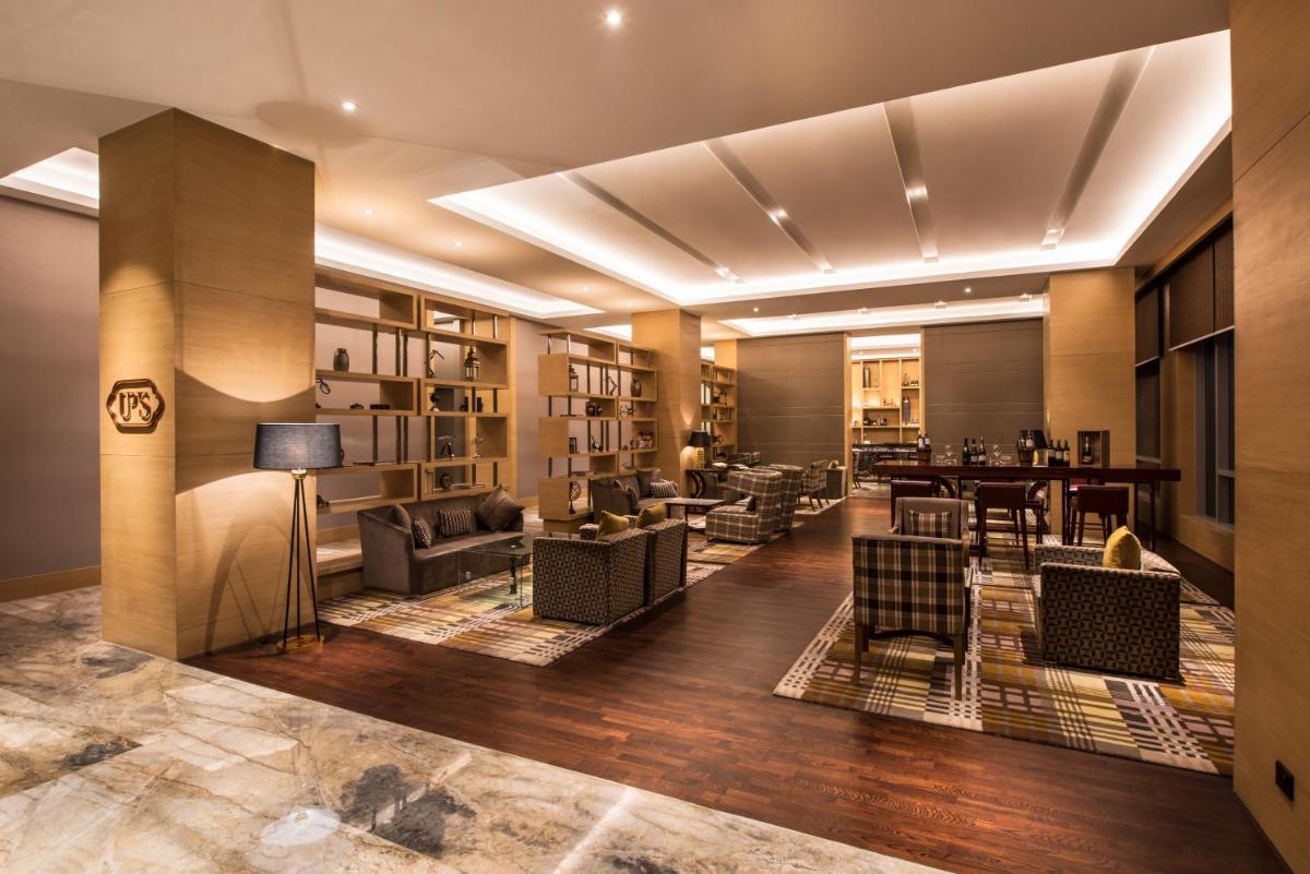 a lobby with couches and chairs and a table at Hyatt Regency Lucknow Gomti Nagar in Lucknow