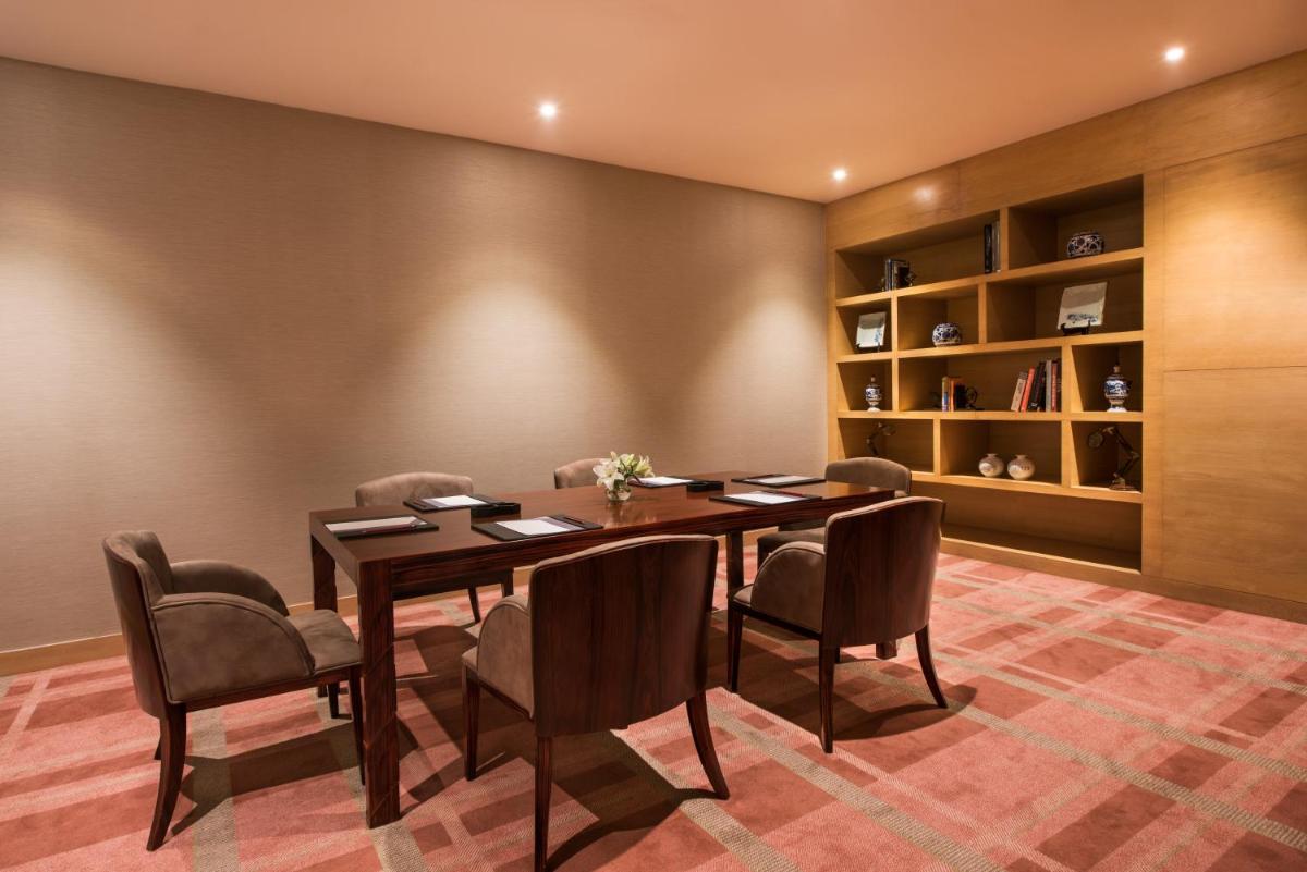 a dining room with a table and chairs at Hyatt Regency Lucknow Gomti Nagar in Lucknow