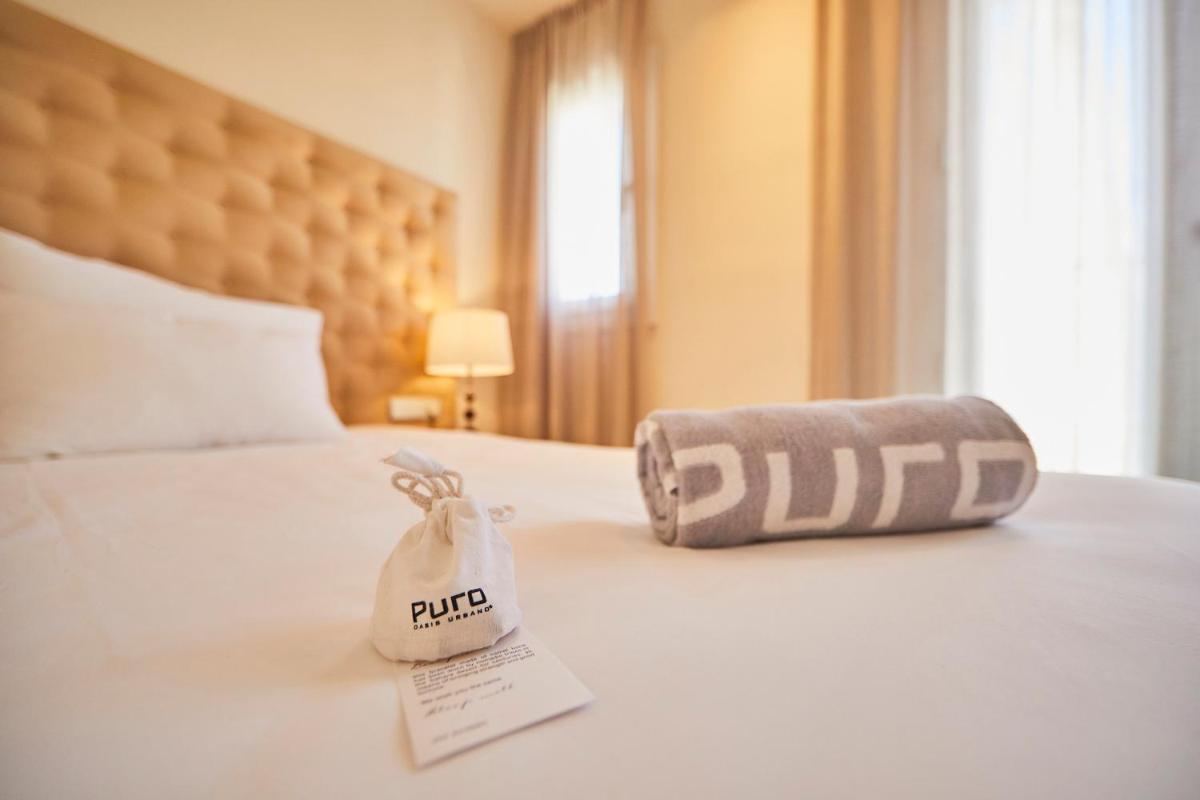 Cama o camas de una habitación en Puro Hotel Oasis Urbano