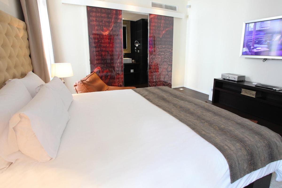 Cama o camas de una habitación en Puro Hotel Oasis Urbano