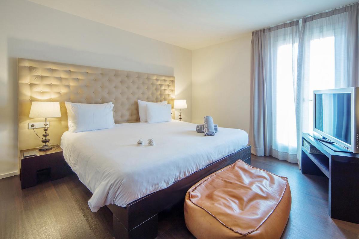 Cama o camas de una habitación en Puro Hotel Oasis Urbano