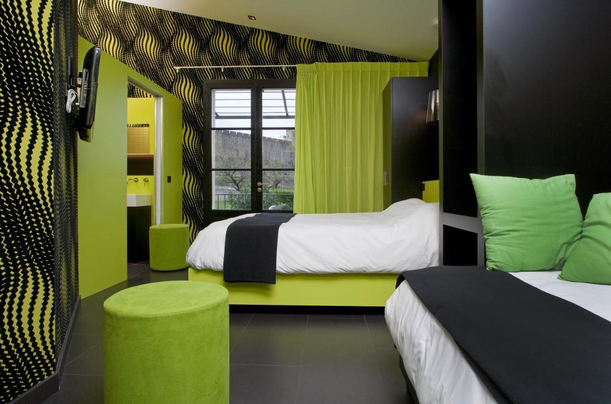 Un ou plusieurs lits dans un hébergement de l'établissement Hôtel Montmorency & Spa