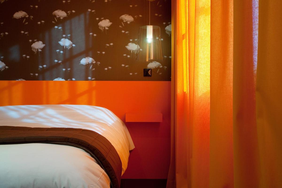 Un ou plusieurs lits dans un hébergement de l'établissement Hôtel Montmorency & Spa