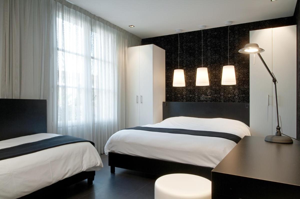 Un ou plusieurs lits dans un hébergement de l'établissement Hôtel Montmorency & Spa
