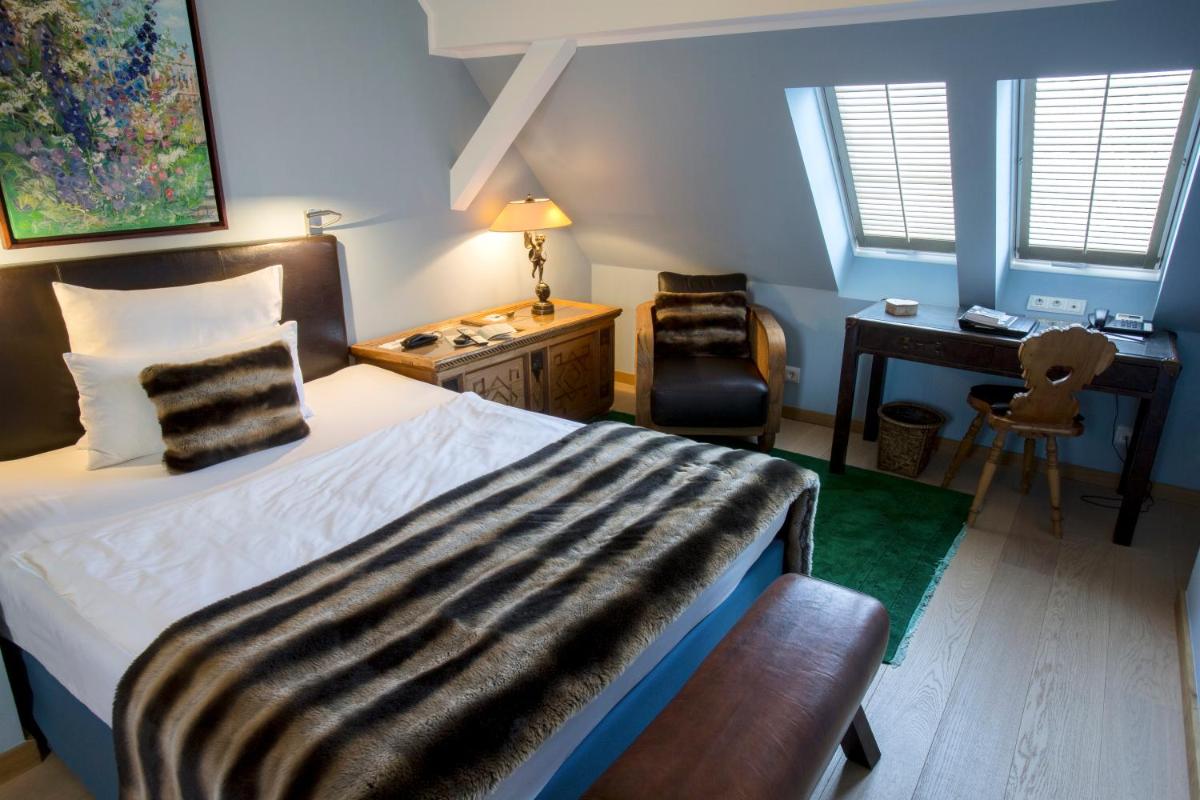 Ein Bett oder Betten in einem Zimmer der Unterkunft Schlosshotel Hugenpoet
