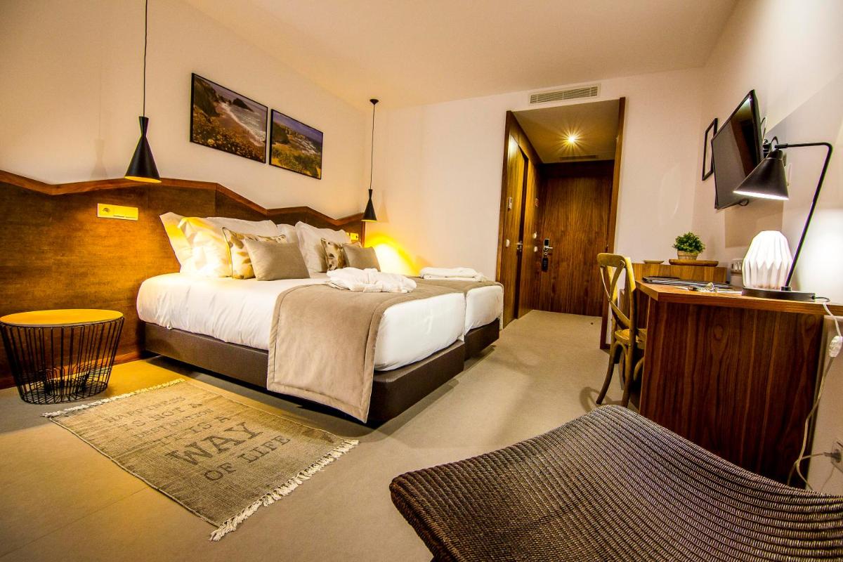 Uma cama ou camas num quarto em Enigma - Nature & Water Hotel