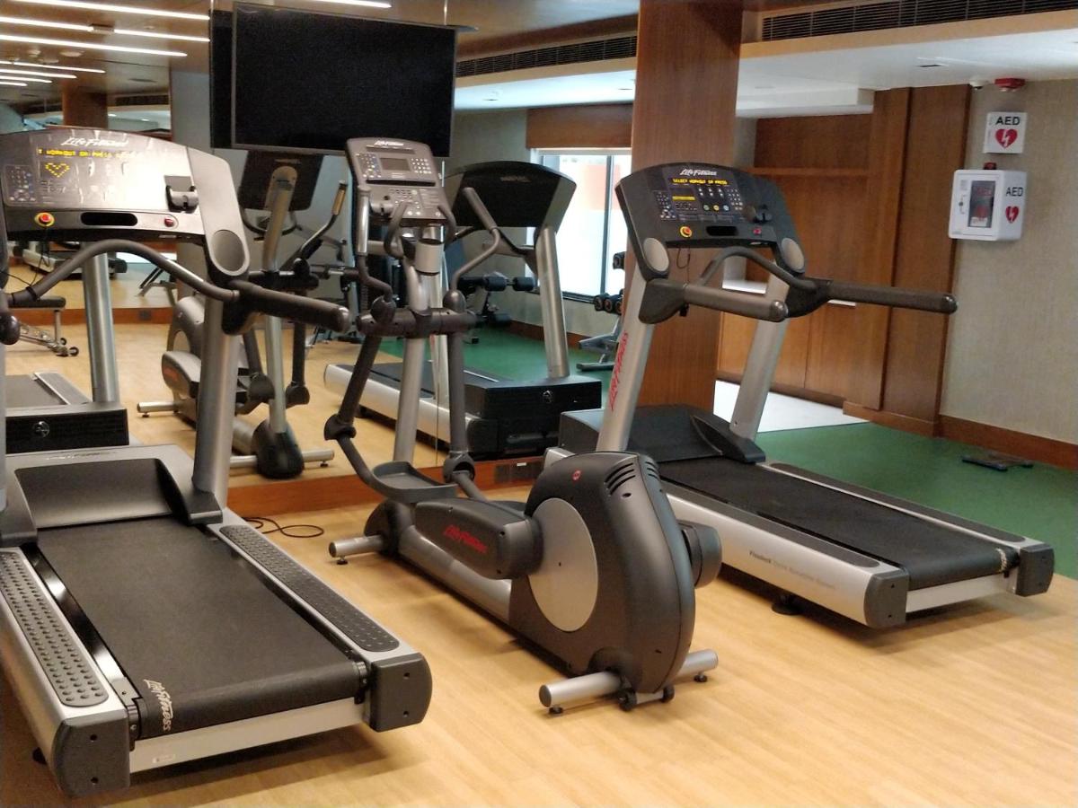 a gym with several exercise bikes and a treadmill at Hyatt Place Hyderabad Banjara Hills in Hyderabad