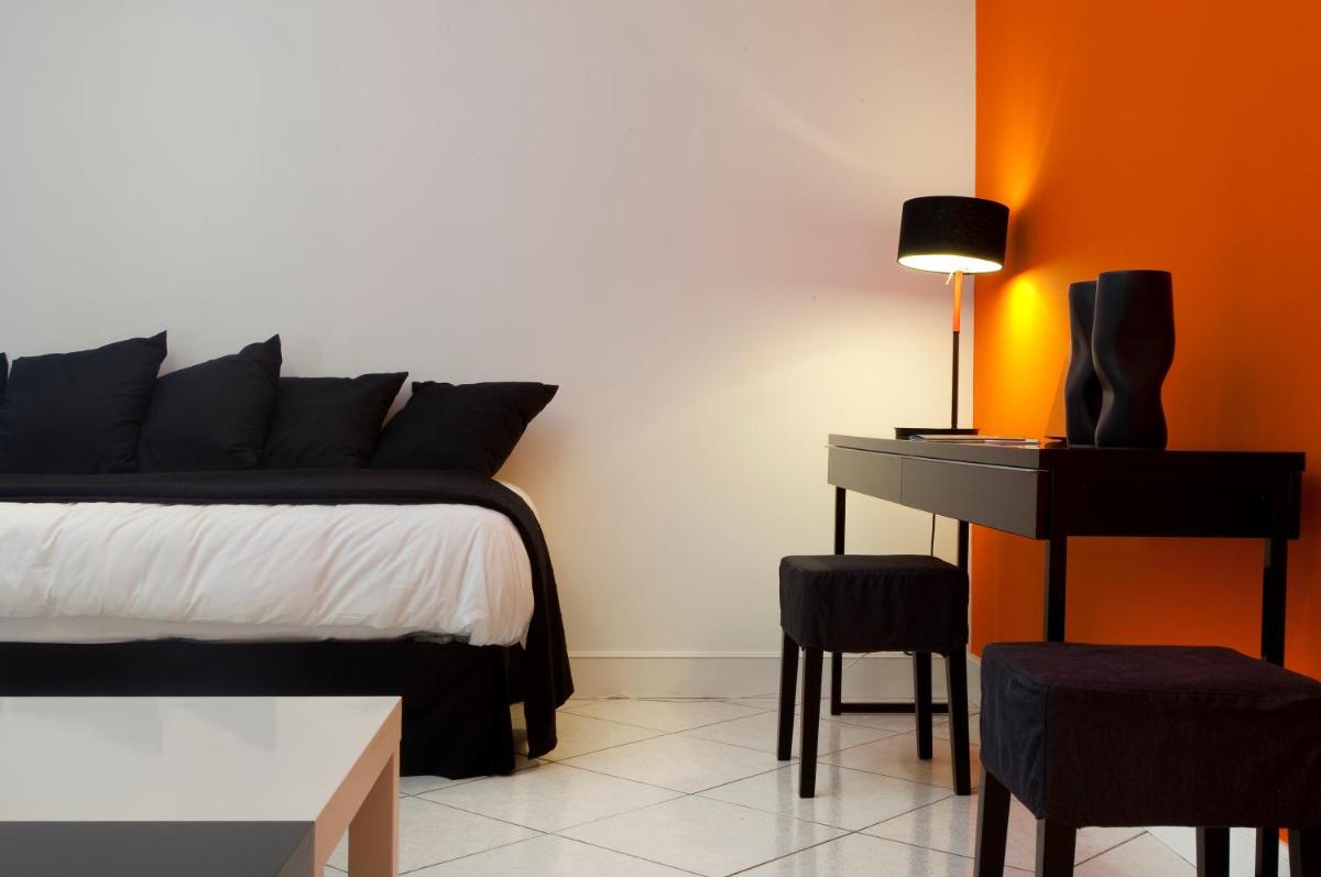 Un ou plusieurs lits dans un hébergement de l'établissement Hôtel De L'octroi