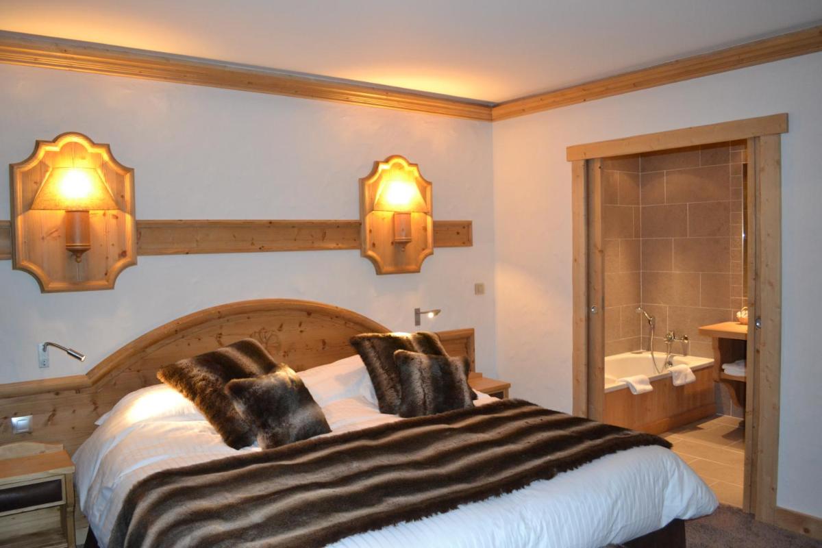 Un ou plusieurs lits dans un hébergement de l'établissement Chalet-Hôtel Neige et Roc, The Originals Relais