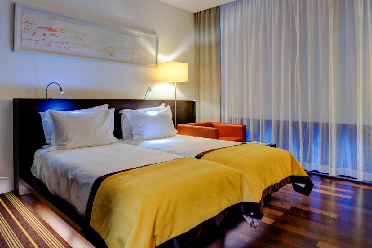 Uma cama ou camas num quarto em VIP Grand Lisboa Hotel & Spa