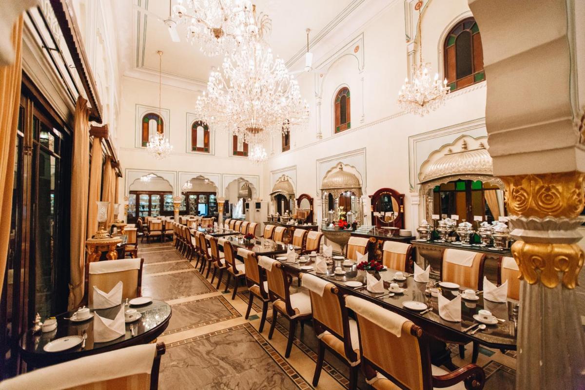 a large dining room with long tables and chairs at The Raj Palace (Small Luxury Hotels of the World) in Jaipur
