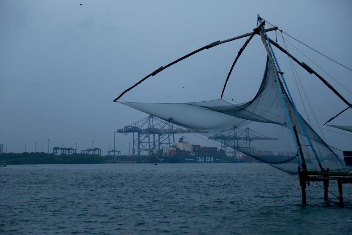 a net in the water with a city in the background at Forte Kochi in Cochin