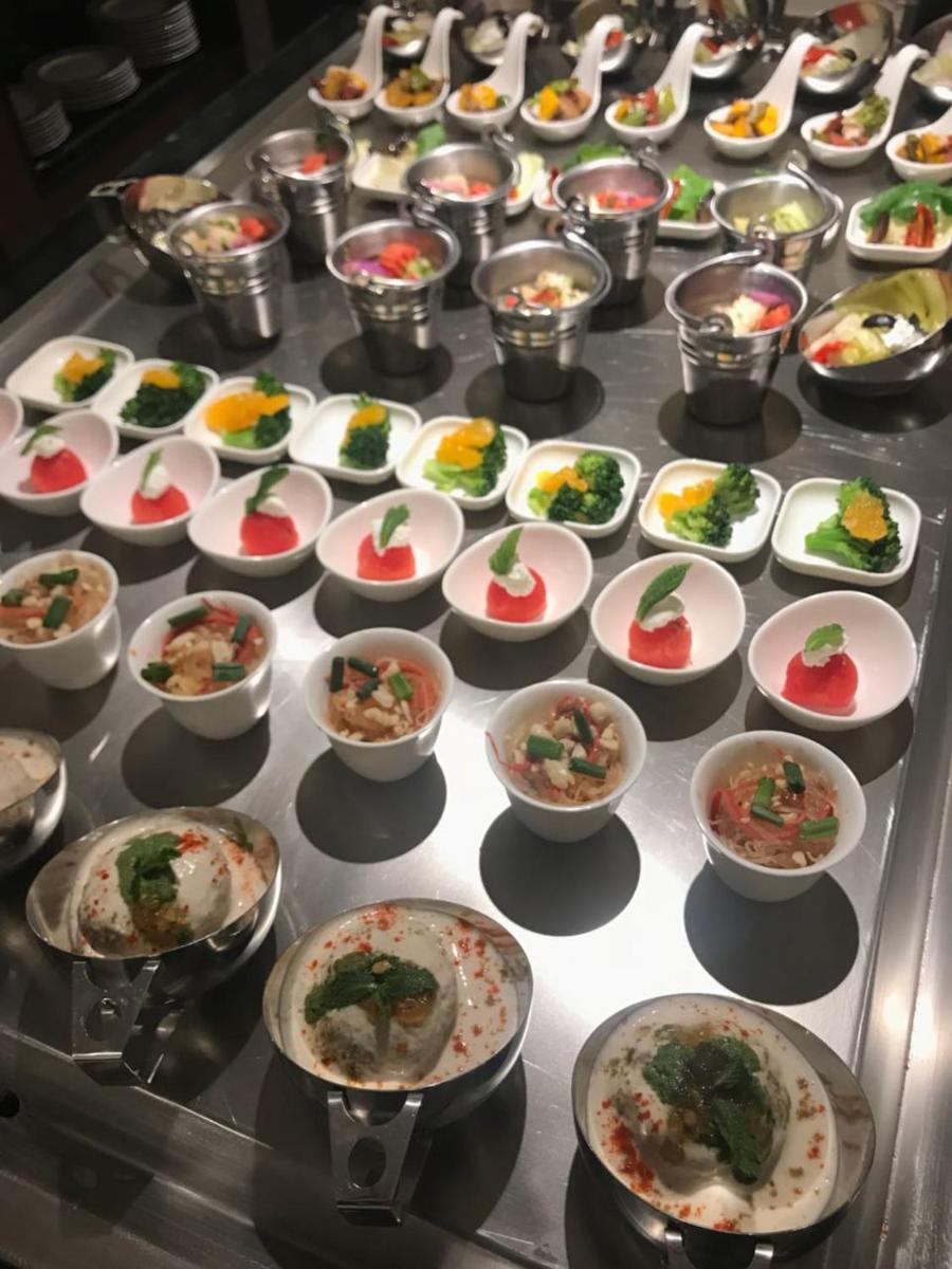 a bunch of bowls of food on a table at Radisson Hotel Shimla in Shimla