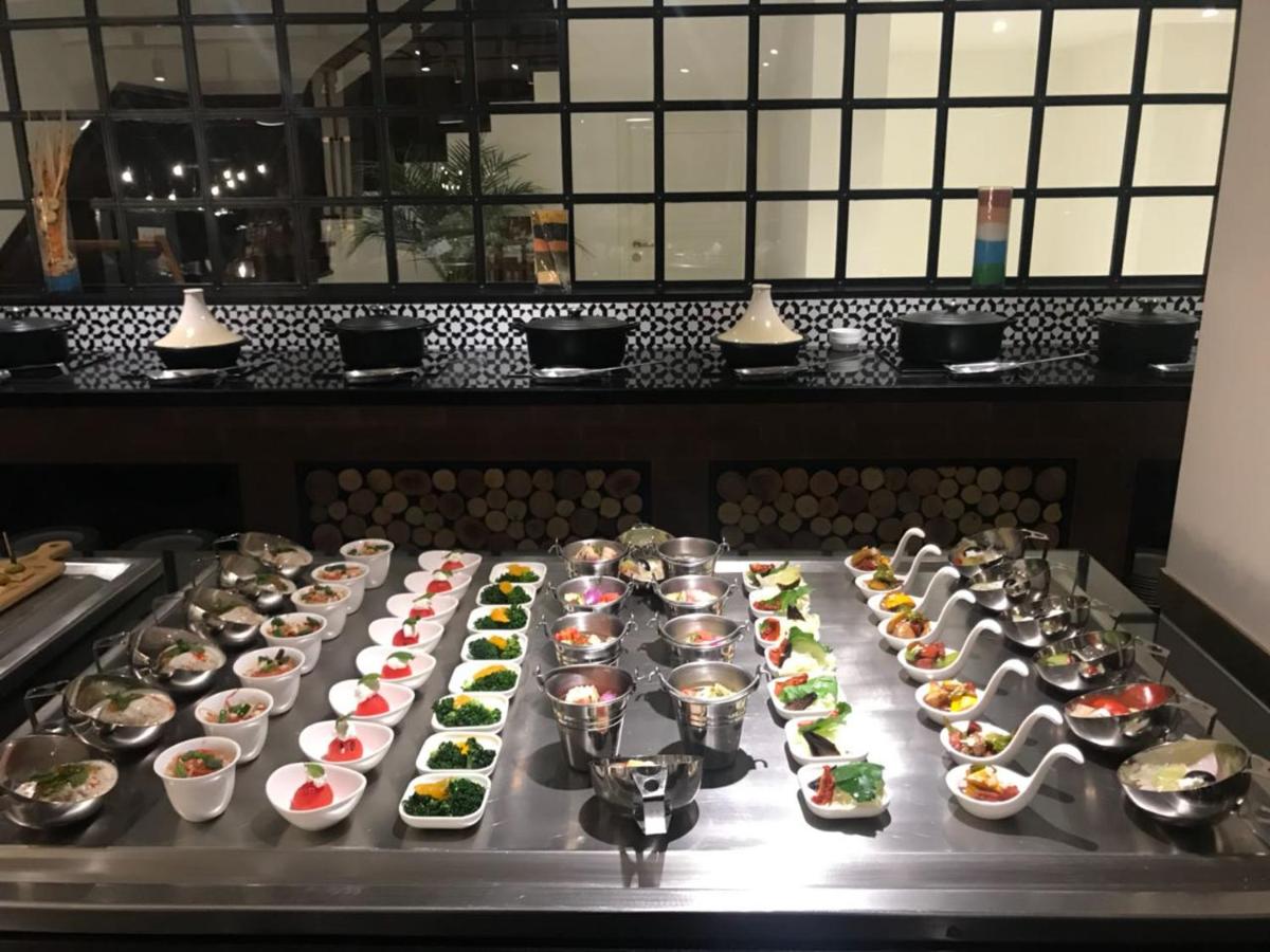 a table with a bunch of different types of food at Radisson Hotel Shimla in Shimla