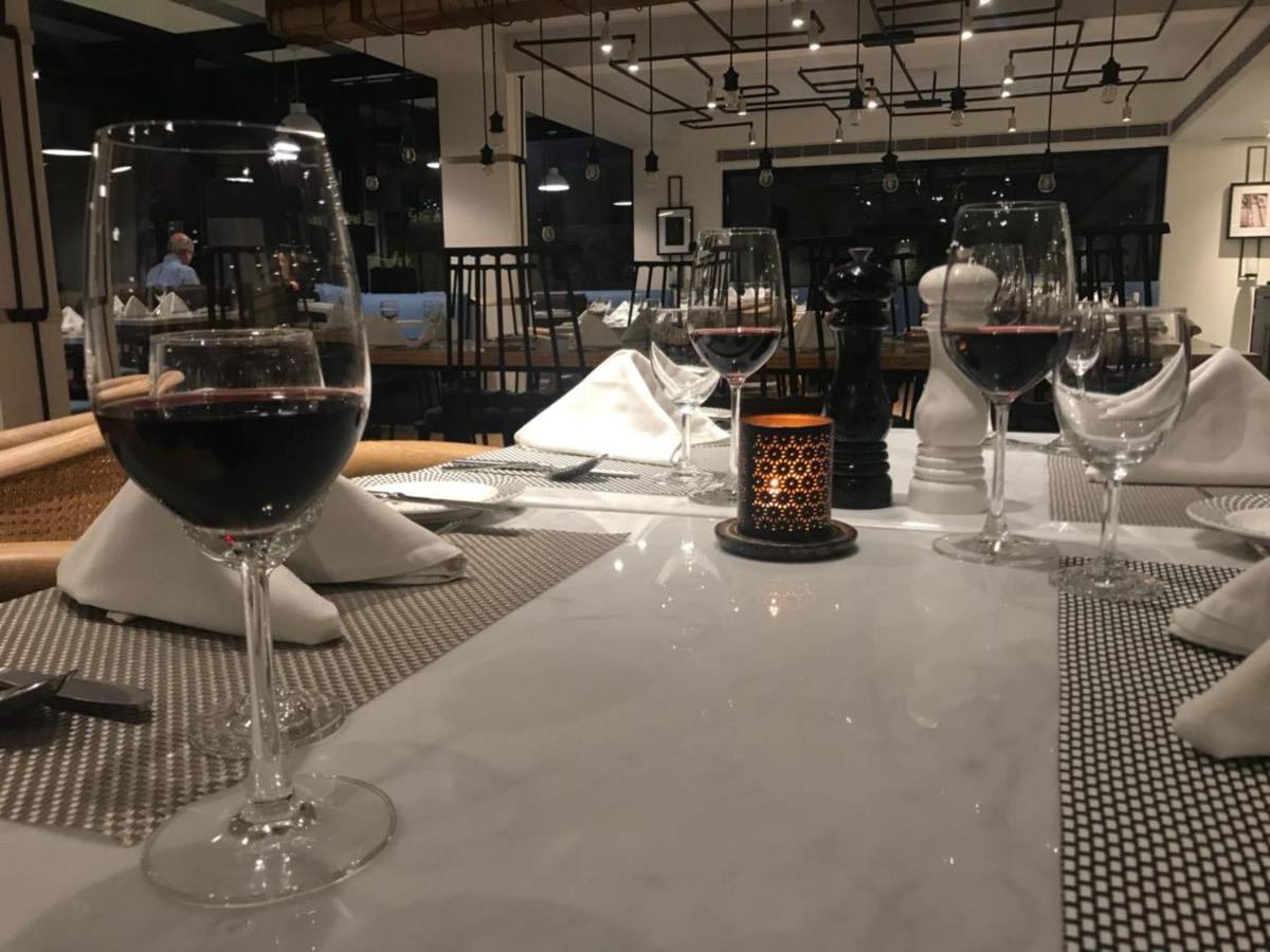 a table with three glasses of wine on it at Radisson Hotel Shimla in Shimla