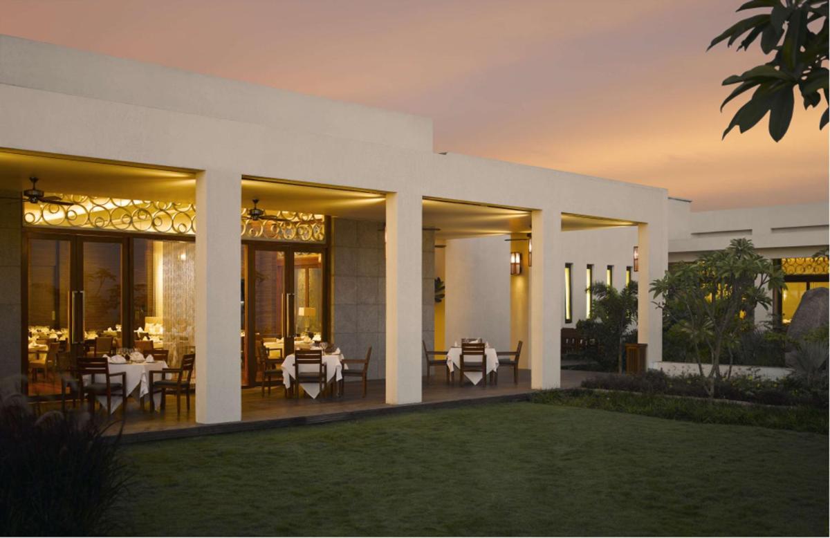 a villa with tables and chairs on a patio at Hyatt Hyderabad Gachibowli in Hyderabad