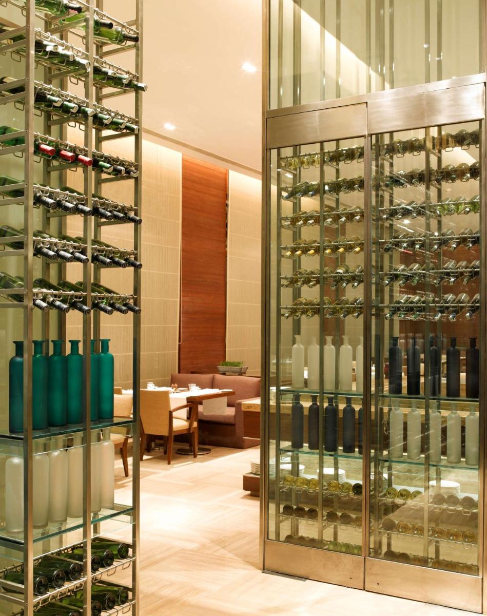 a wine cellar with a wall of wine bottles at Hyatt Hyderabad Gachibowli in Hyderabad