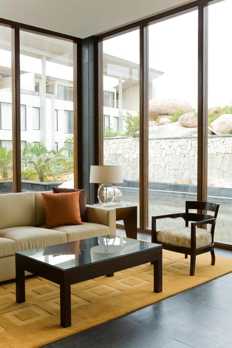 a living room with a couch and a coffee table at Hyatt Hyderabad Gachibowli in Hyderabad