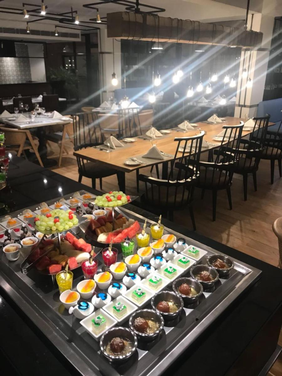 a buffet of food on a table in a restaurant at Radisson Hotel Shimla in Shimla