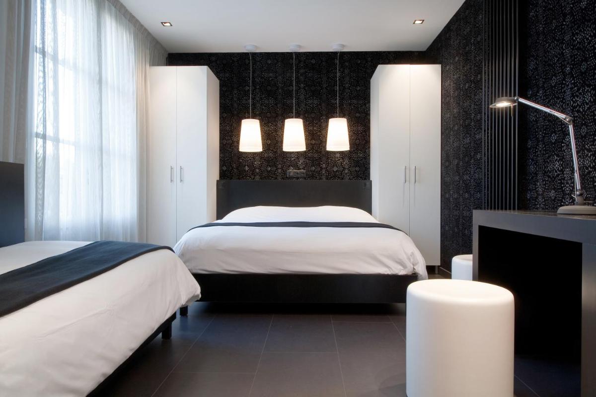 Un ou plusieurs lits dans un hébergement de l'établissement Hôtel Montmorency & Spa