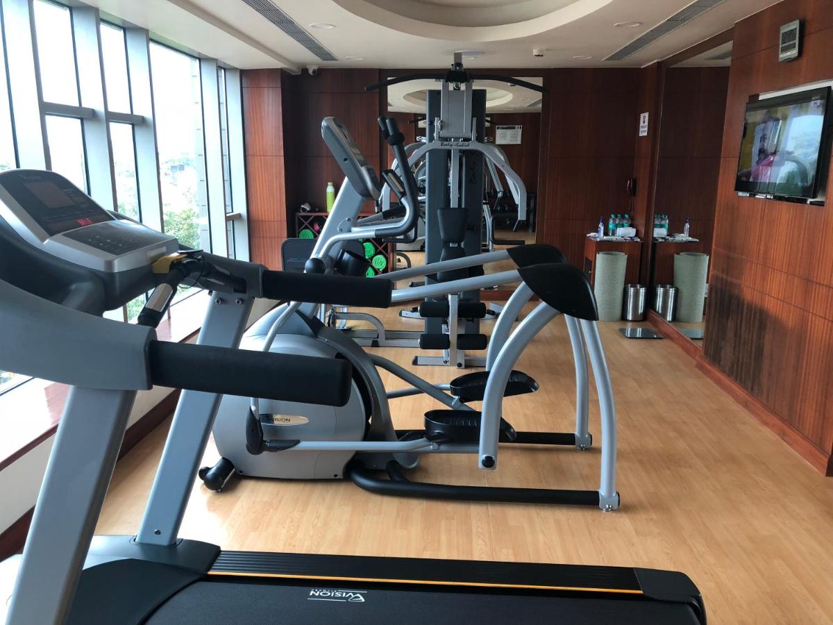a gym with several tread machines in a room at Fortune Miramar, Goa - Member ITC Hotels' Group in Panaji a gym with several tread machines in a room at Fortune Miramar, Goa - Member ITC Hotels' Group in Panaji