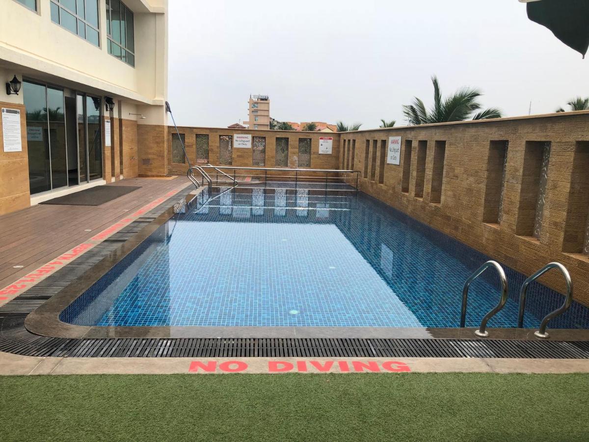 a swimming pool with a no diving sign next to a building at Fortune Miramar, Goa - Member ITC Hotels' Group in Panaji a swimming pool with a no diving sign next to a building at Fortune Miramar, Goa - Member ITC Hotels' Group in Panaji