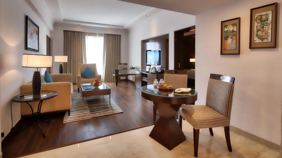 a room with a living room and a dining room at Radisson Jaipur City Center in Jaipur
