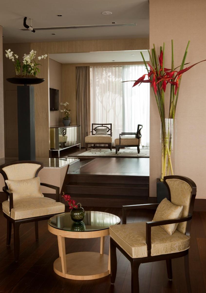 a living room with chairs and a table and a couch at Taj Lands End in Mumbai a living room with chairs and a table and a couch at Taj Lands End in Mumbai