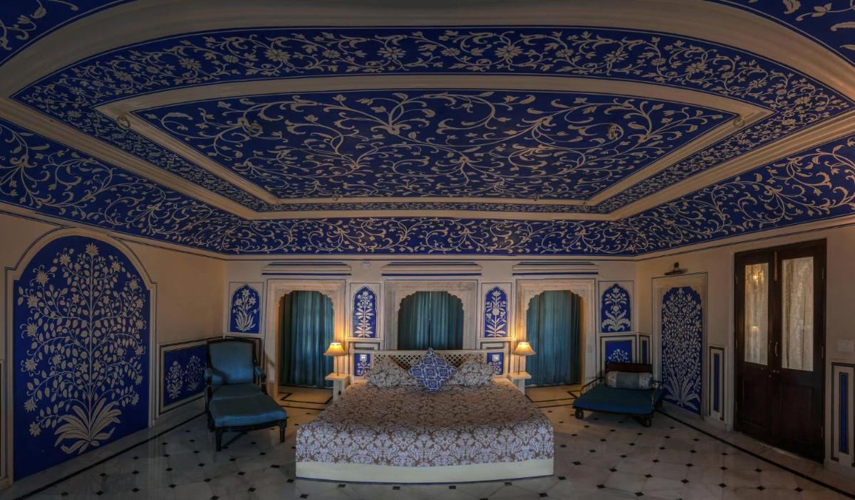 a bedroom with a bed in a blue and white room at Royal Heritage Haveli - By Leisure Hotels in Jaipur